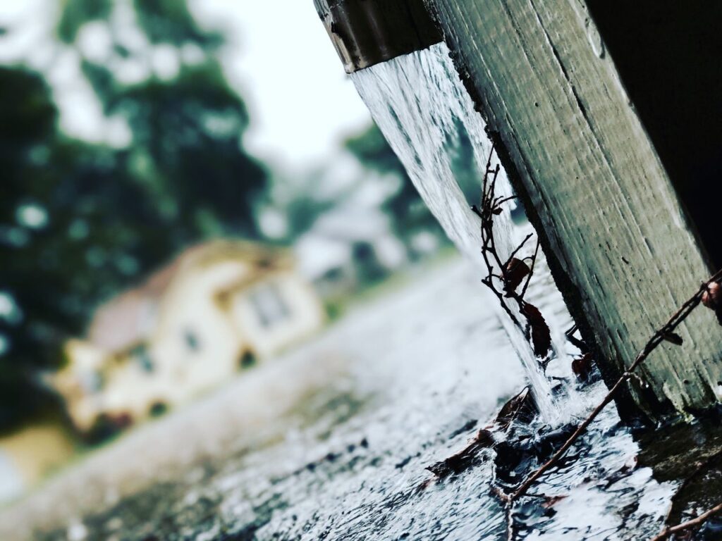 Mastering the First Impression: Your intriguing post title goes here Close-up of rainwater flowing from a gutter during a storm, capturing the essence of rainy weather.
